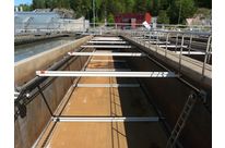 Surface sludge scraper