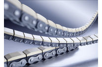 Roller chain with vulcanised elastomer profiles